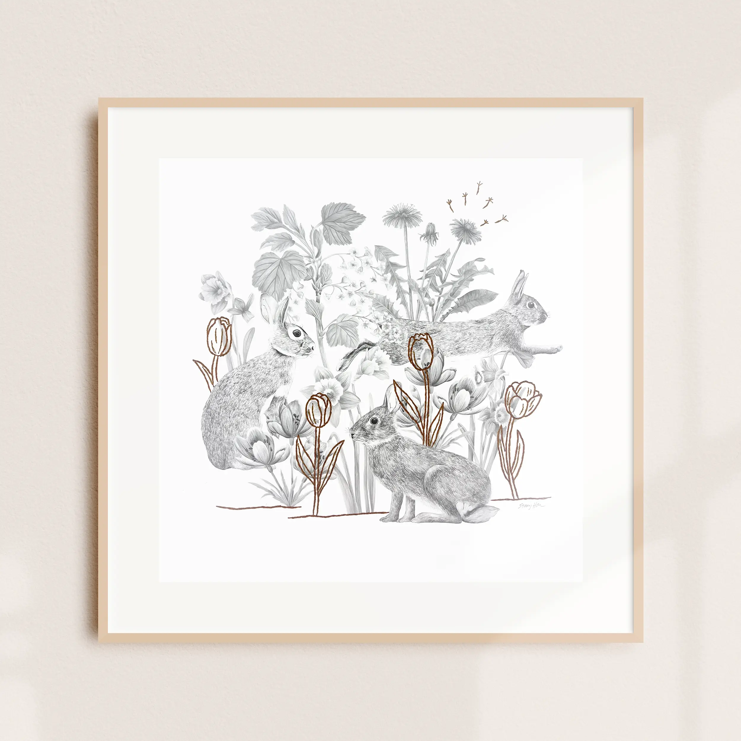 A framed illustration of rabbits among foliage