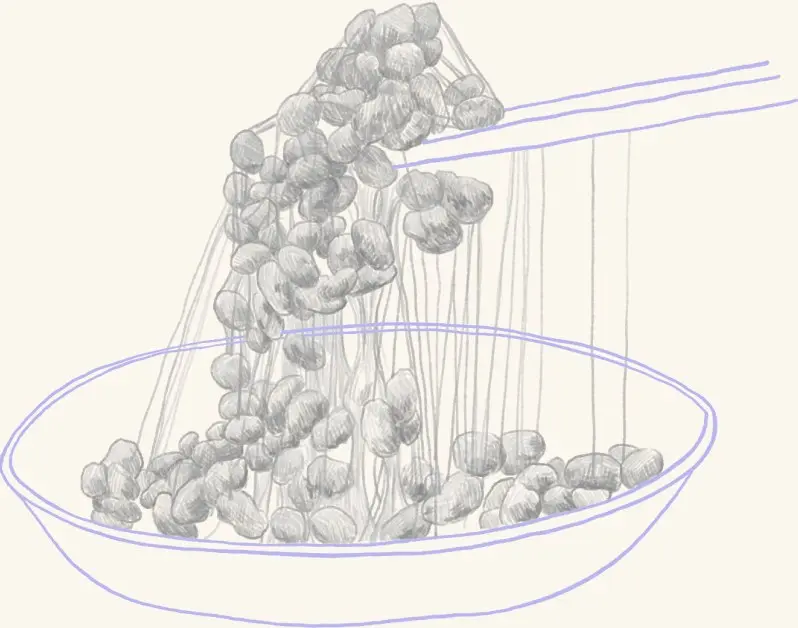 Natto lifted with chopsticks in sticky strands