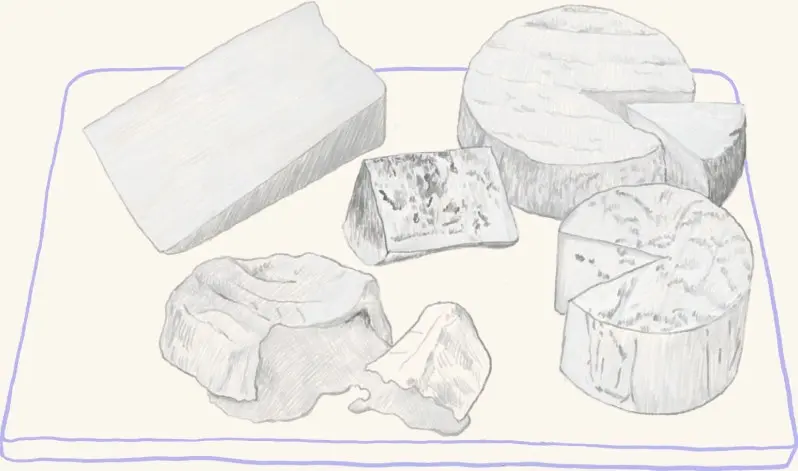 An assortment of cheeses on a board