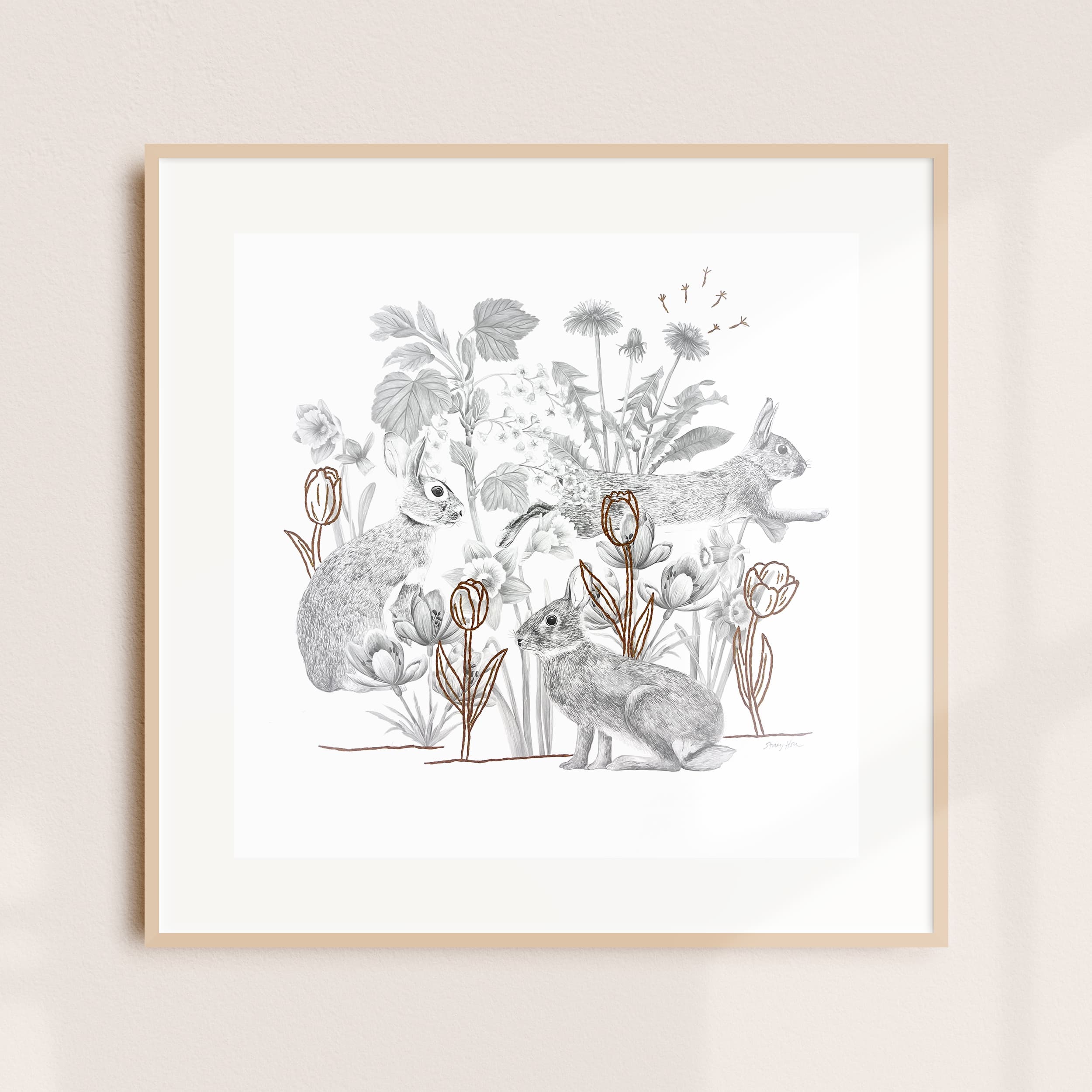 A framed illustration of rabbits among foliage