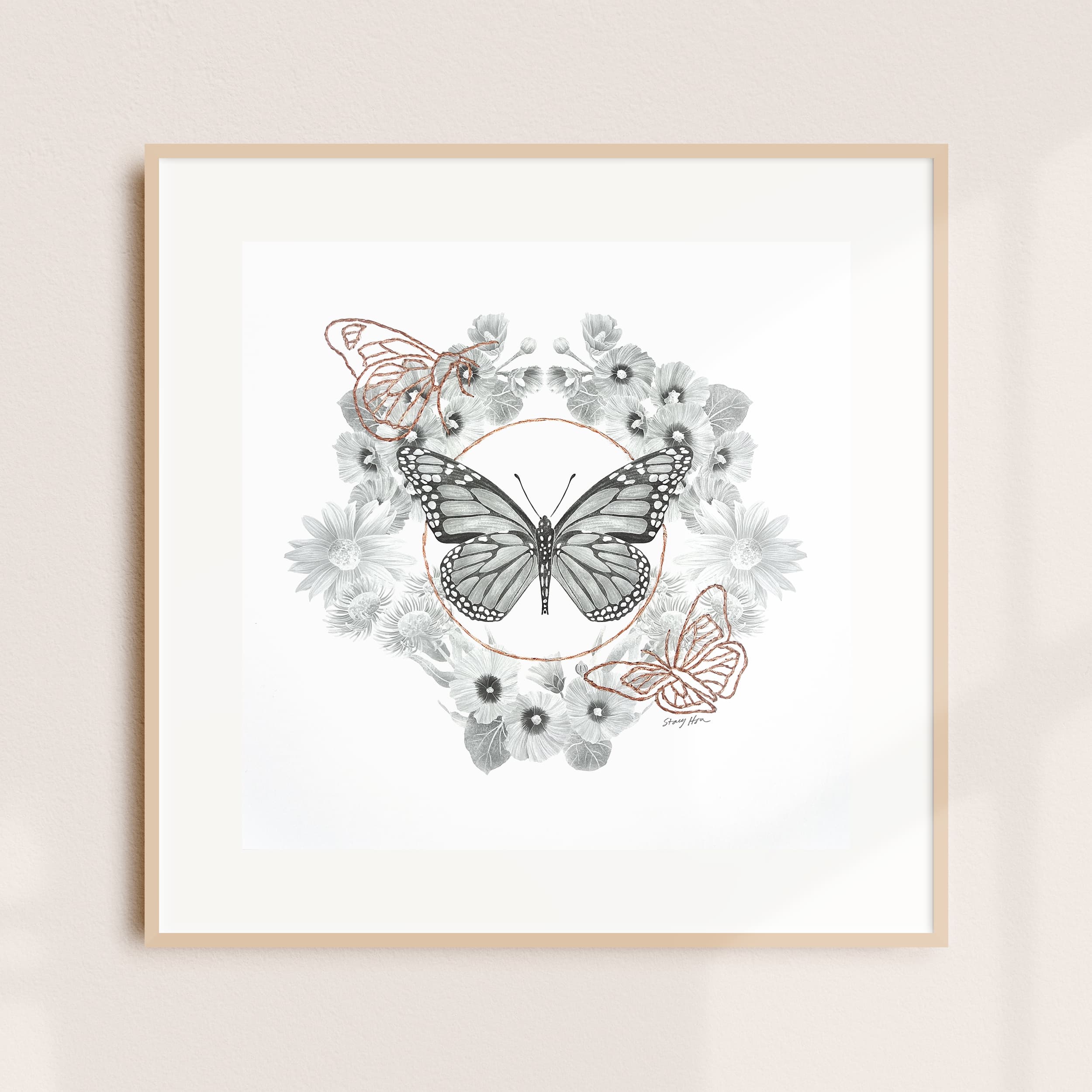 A framed illustration of a butterfly wreath