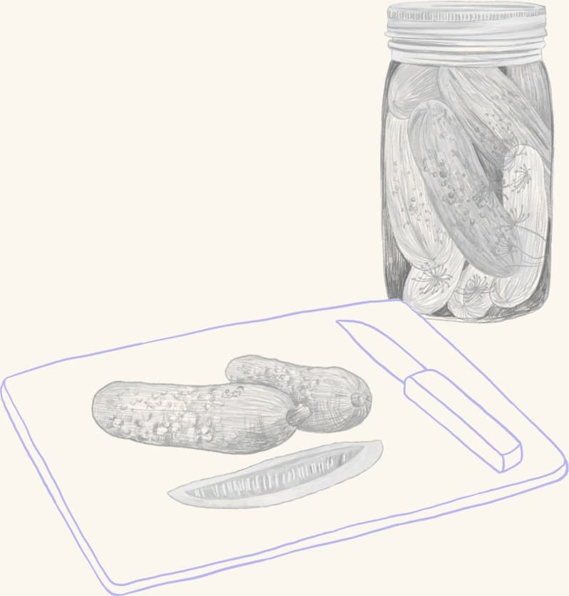 A jar of pickles beside sliced cucumbers on a cutting board